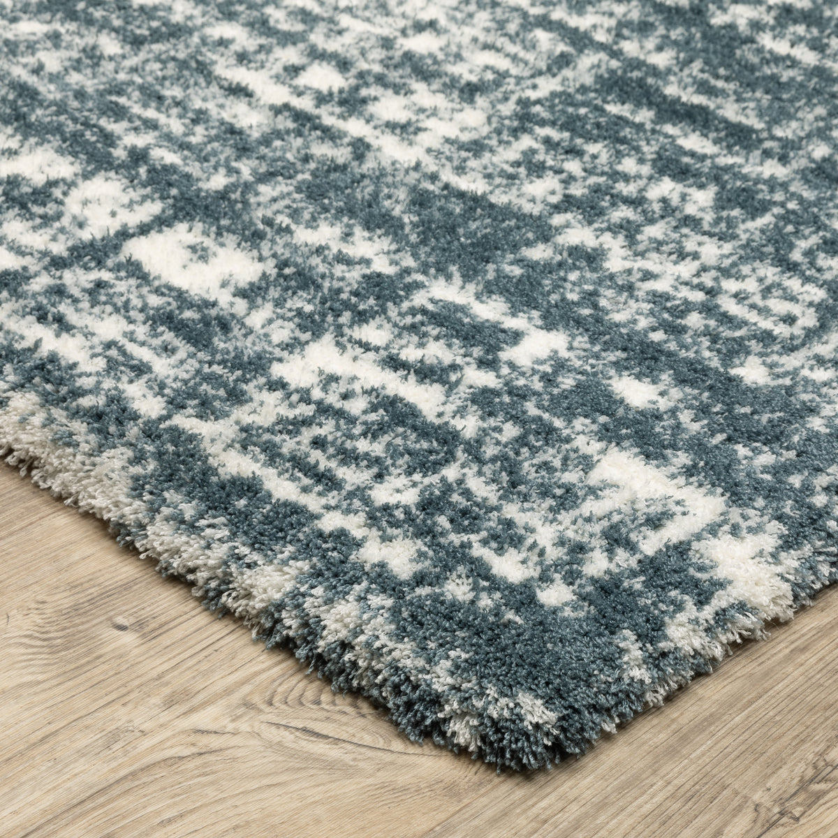Modern teal and white textured area rug with abstract distressed pattern
