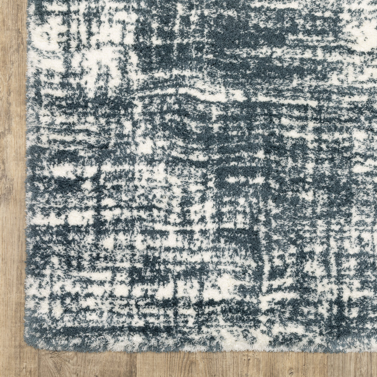 Modern teal and white textured area rug with abstract distressed pattern