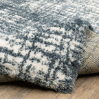 Modern teal and white textured area rug with abstract distressed pattern