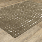 Grey wool rug with white polka dot pattern and textured surface
