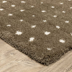 Grey wool rug with white polka dot pattern and textured surface