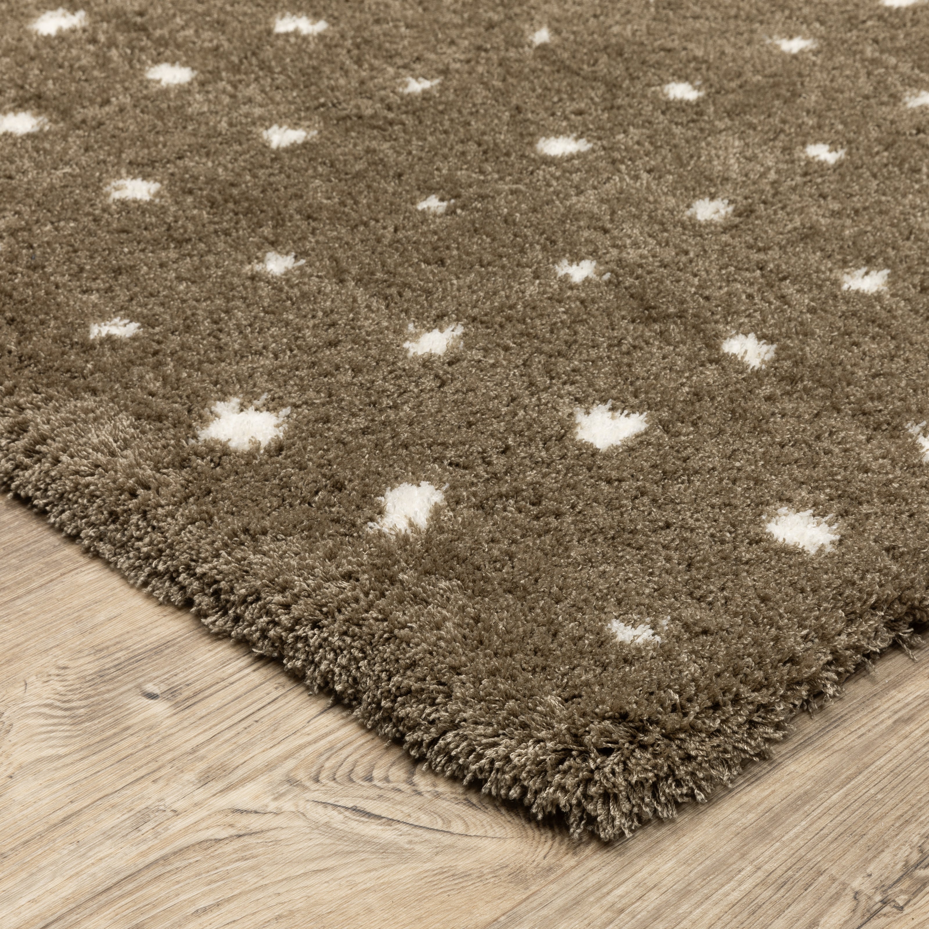 Grey wool rug with white polka dot pattern and textured surface