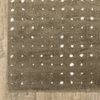Grey wool rug with white polka dot pattern and textured surface