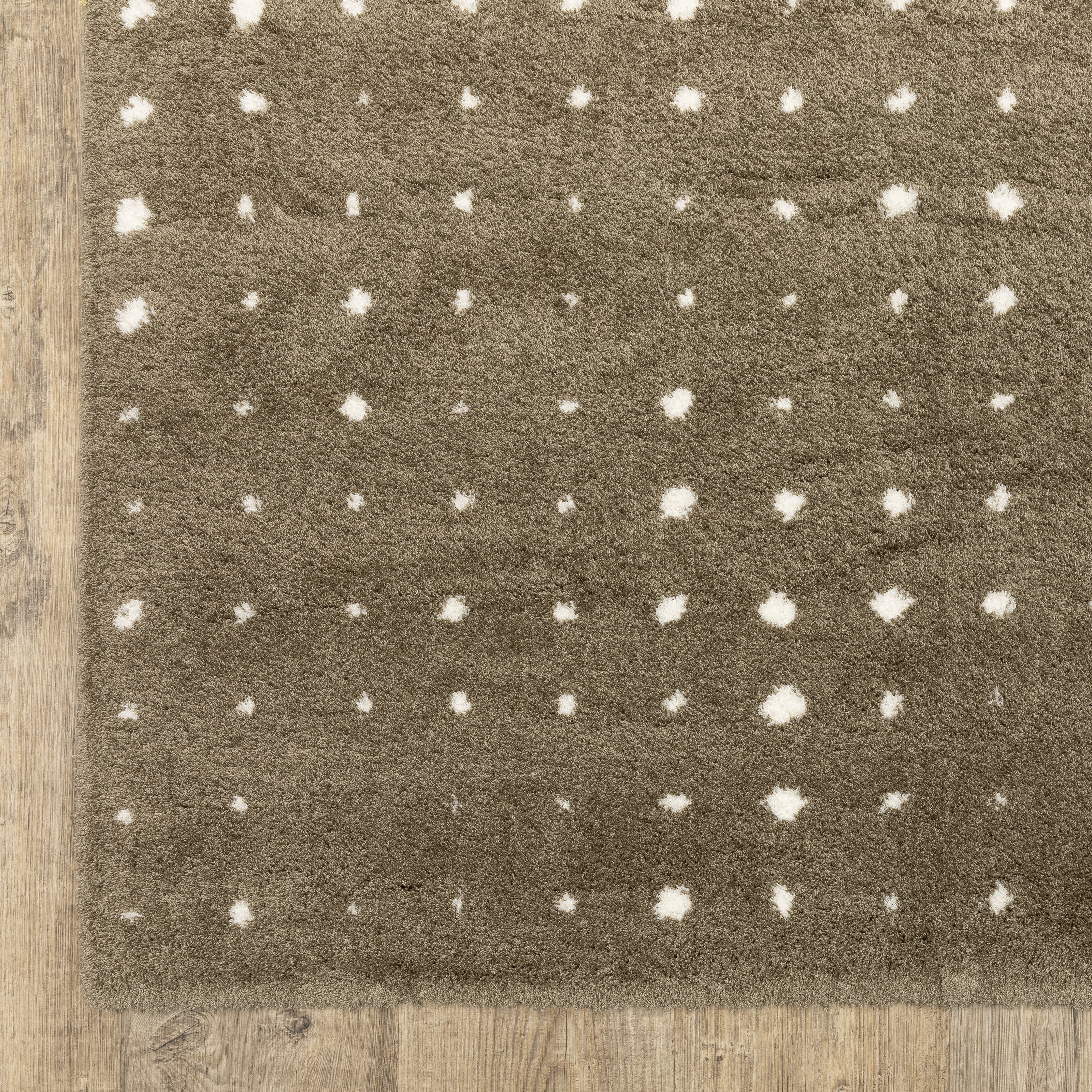 Grey wool rug with white polka dot pattern and textured surface