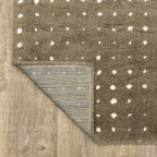 Grey wool rug with white polka dot pattern and textured surface