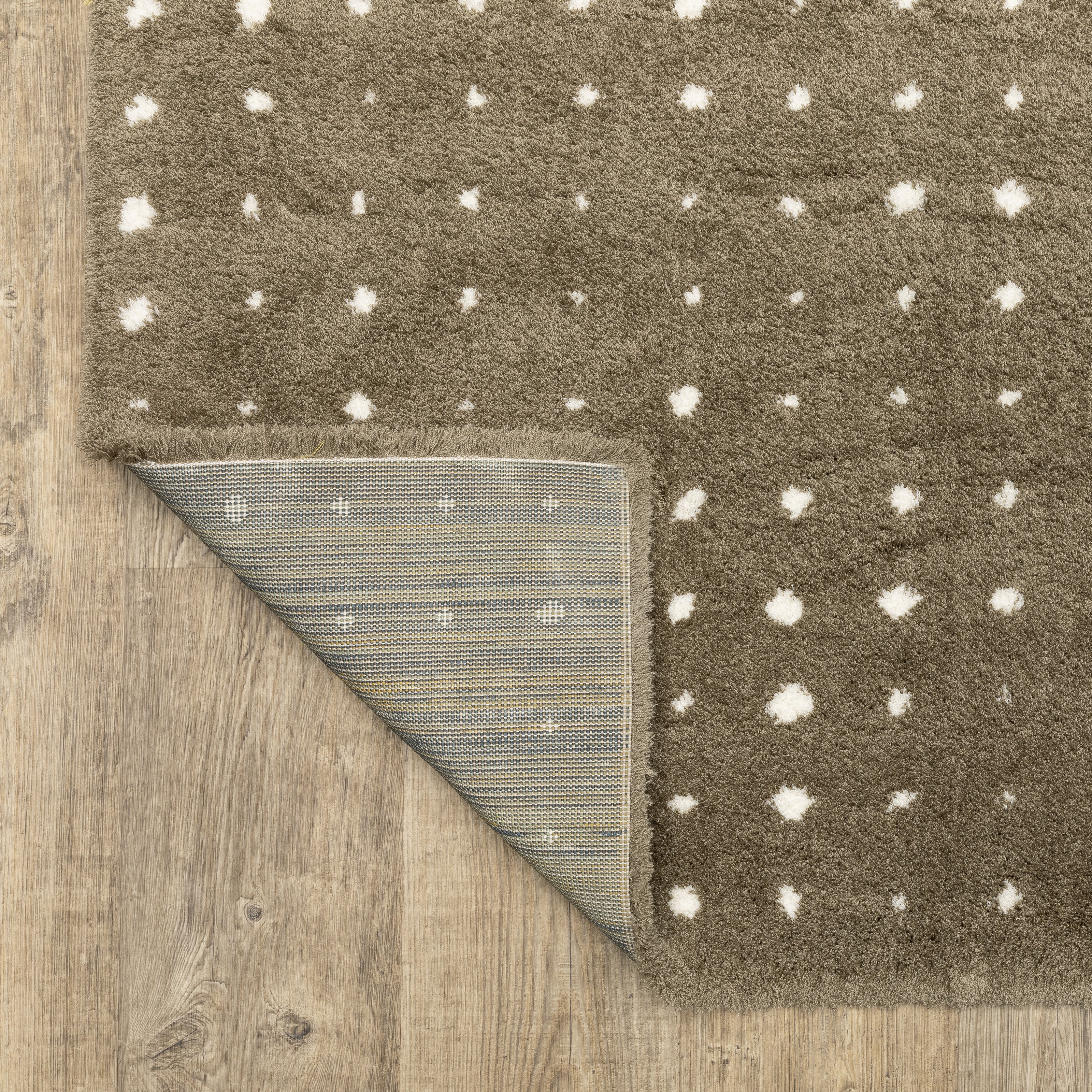 Grey wool rug with white polka dot pattern and textured surface