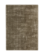 Grey wool rug with white polka dot pattern and textured surface