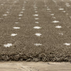 Grey wool rug with white polka dot pattern and textured surface