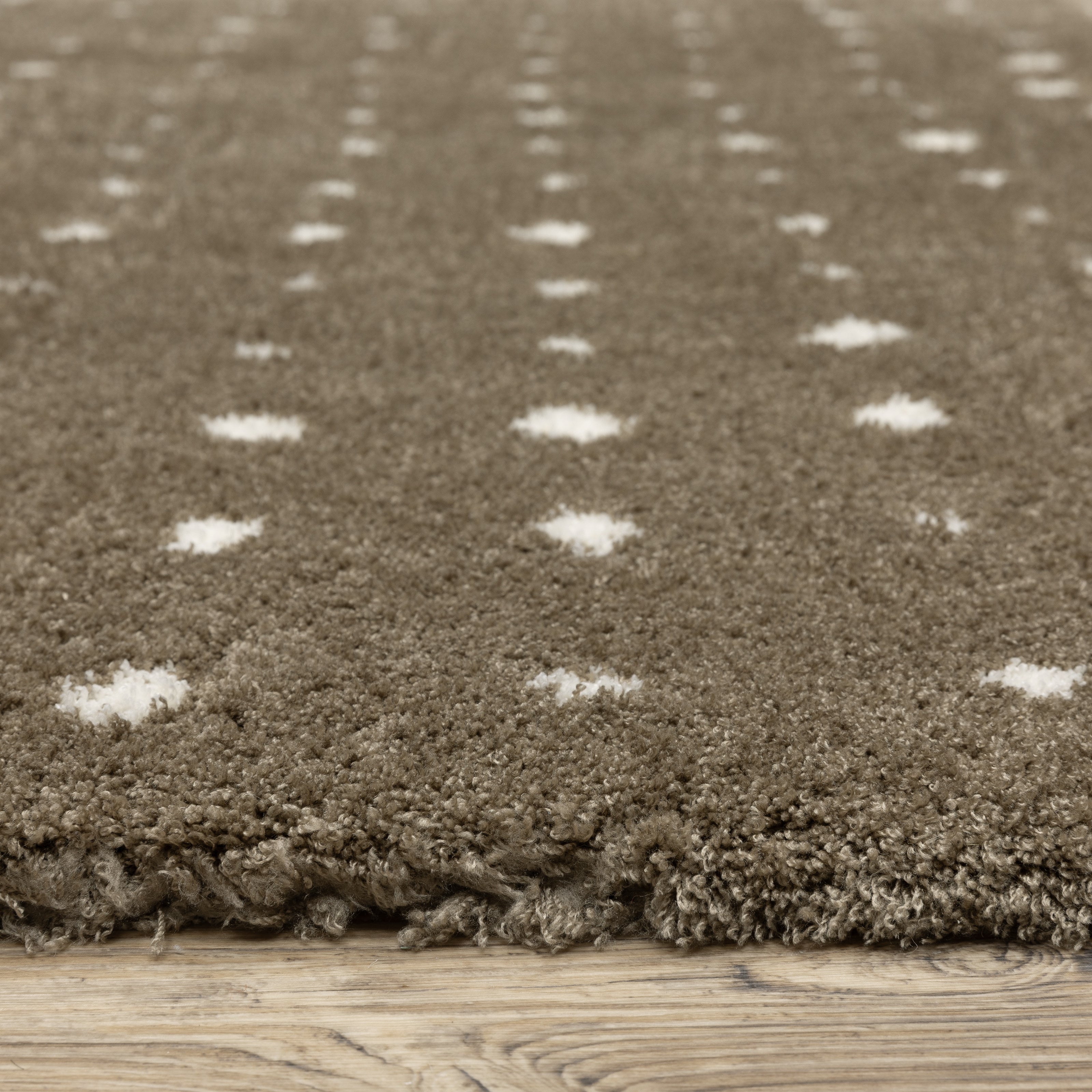 Grey wool rug with white polka dot pattern and textured surface