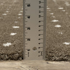 Grey wool rug with white polka dot pattern and textured surface
