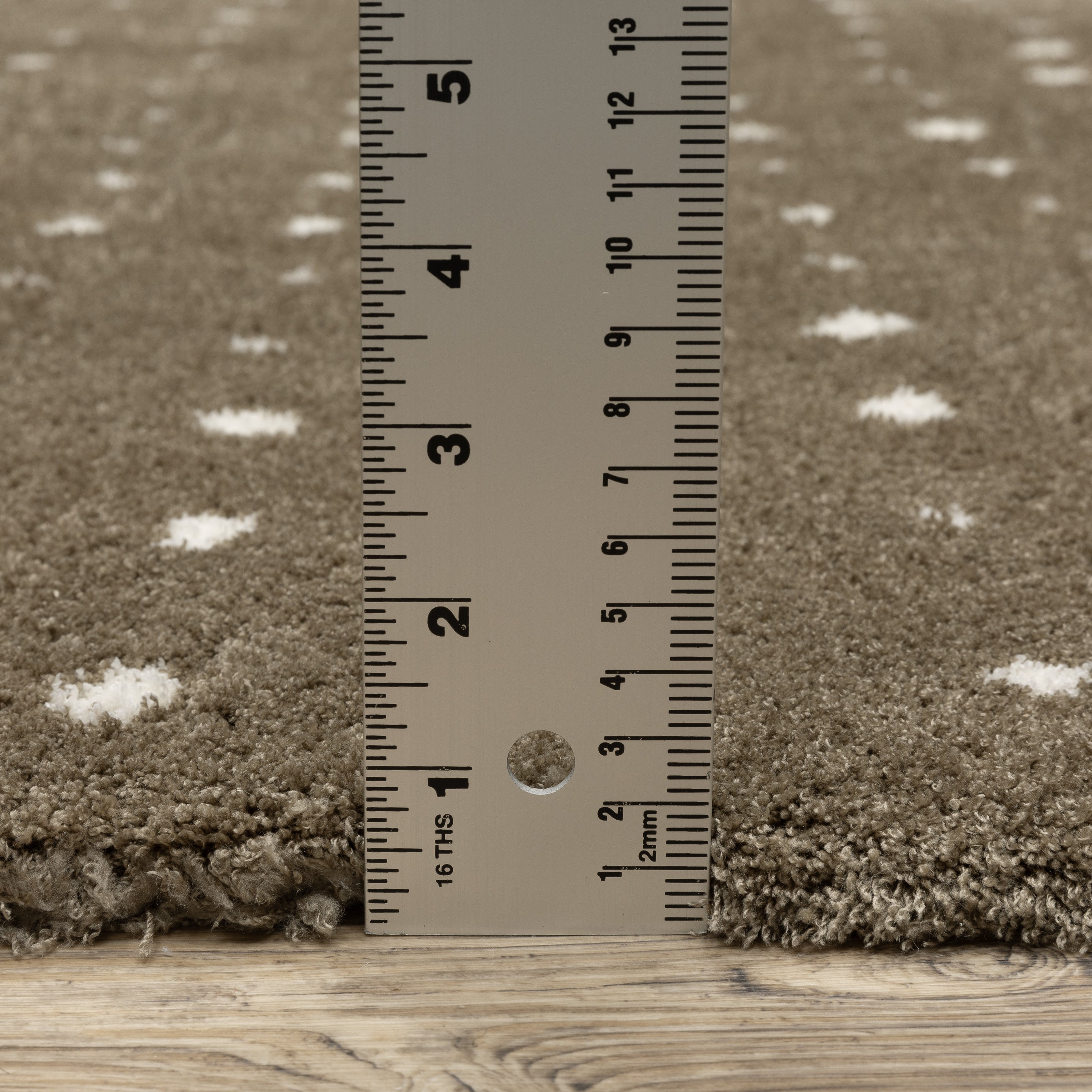 Grey wool rug with white polka dot pattern and textured surface