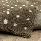 Grey wool rug with white polka dot pattern and textured surface