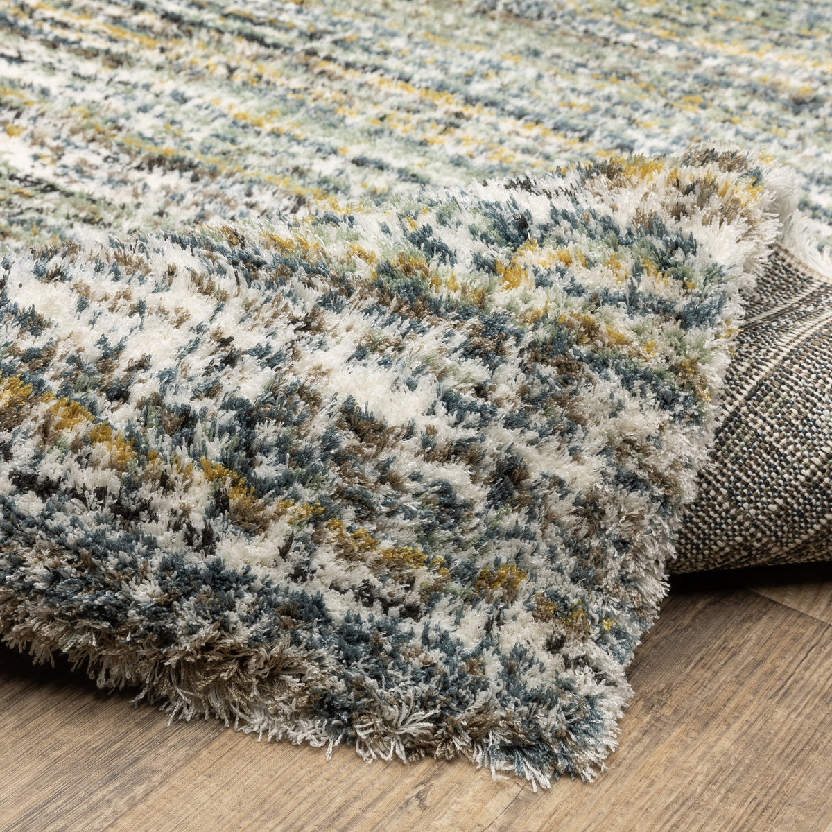 Textured striped area rug in grey, blue, green and cream tones