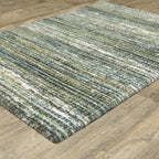 Textured striped area rug in grey, blue, green and cream tones