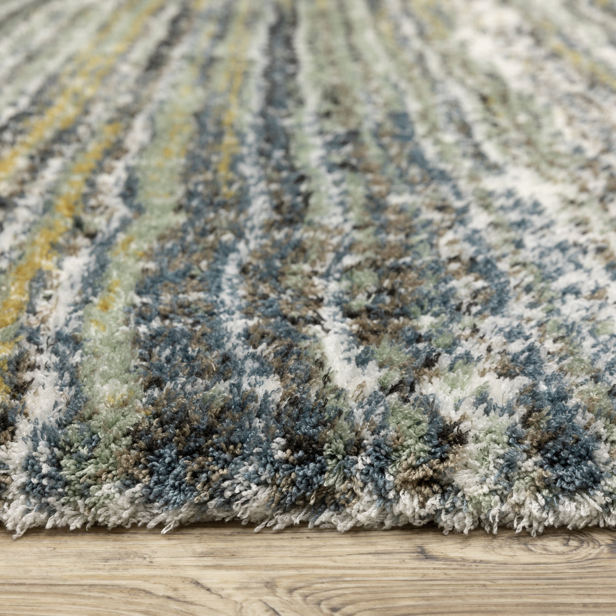Textured striped area rug in grey, blue, green and cream tones