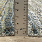 Textured striped area rug in grey, blue, green and cream tones