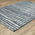 Teal and white striped wool rug with textured horizontal pattern detail