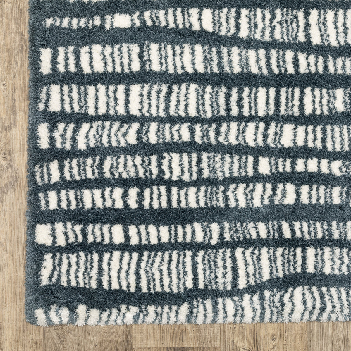 Teal and white striped wool rug with textured horizontal pattern detail