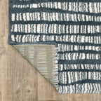 Teal and white striped wool rug with textured horizontal pattern detail
