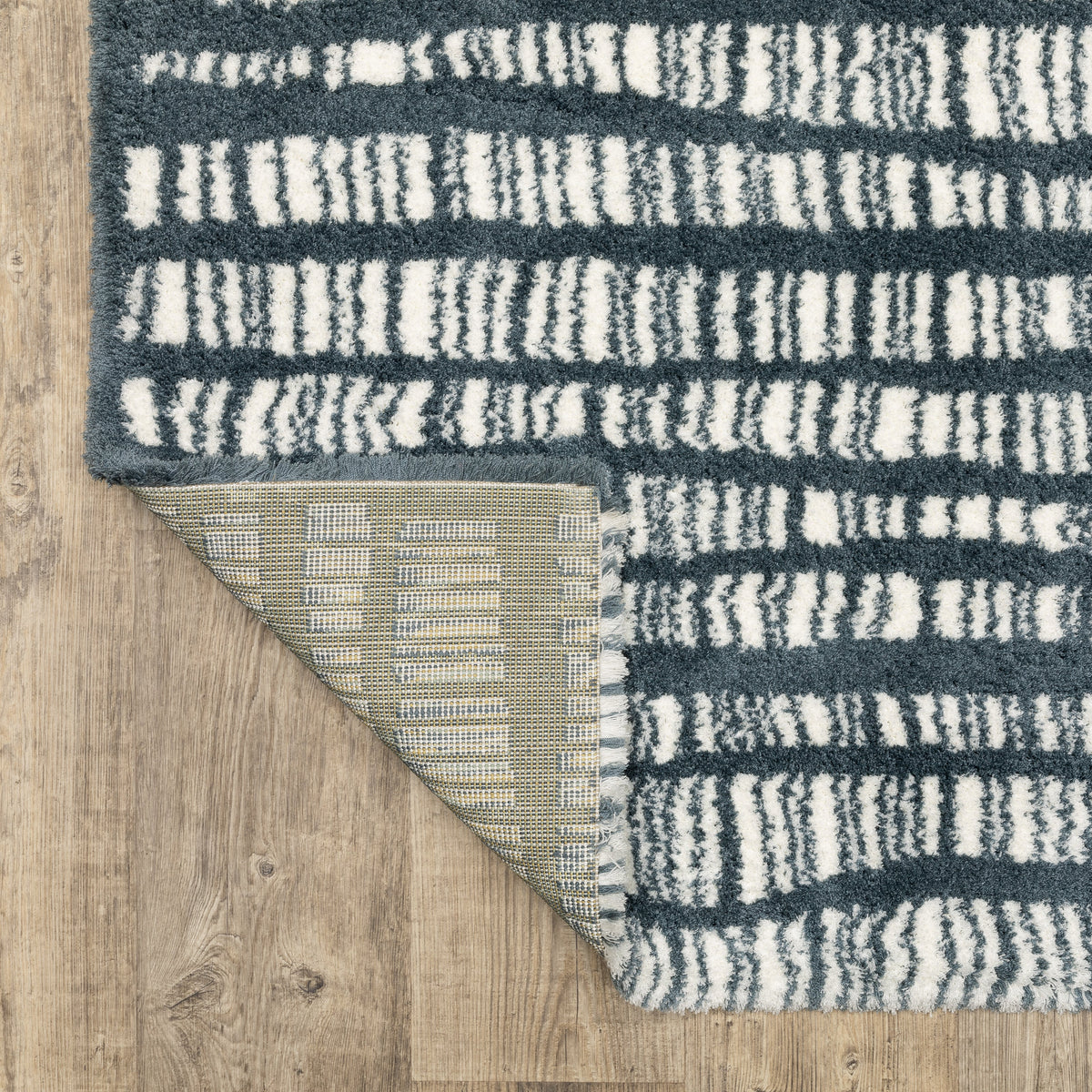 Teal and white striped wool rug with textured horizontal pattern detail