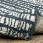 Teal and white striped wool rug with textured horizontal pattern detail
