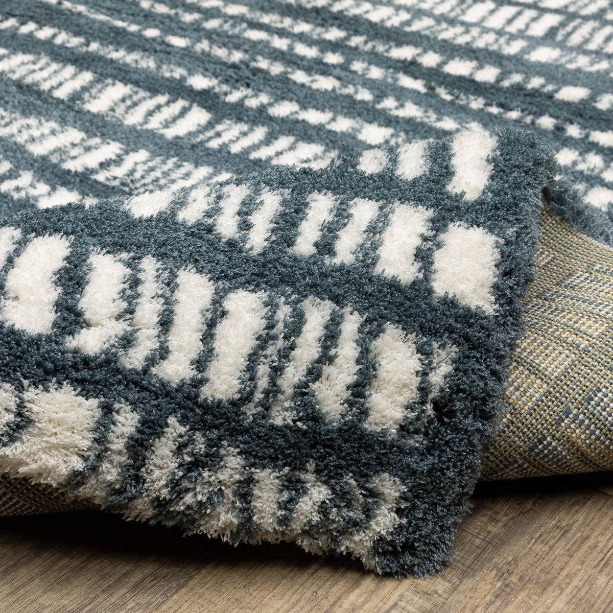 Teal and white striped wool rug with textured horizontal pattern detail