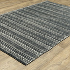 Charcoal grey striped wool rug with horizontal woven texture pattern
