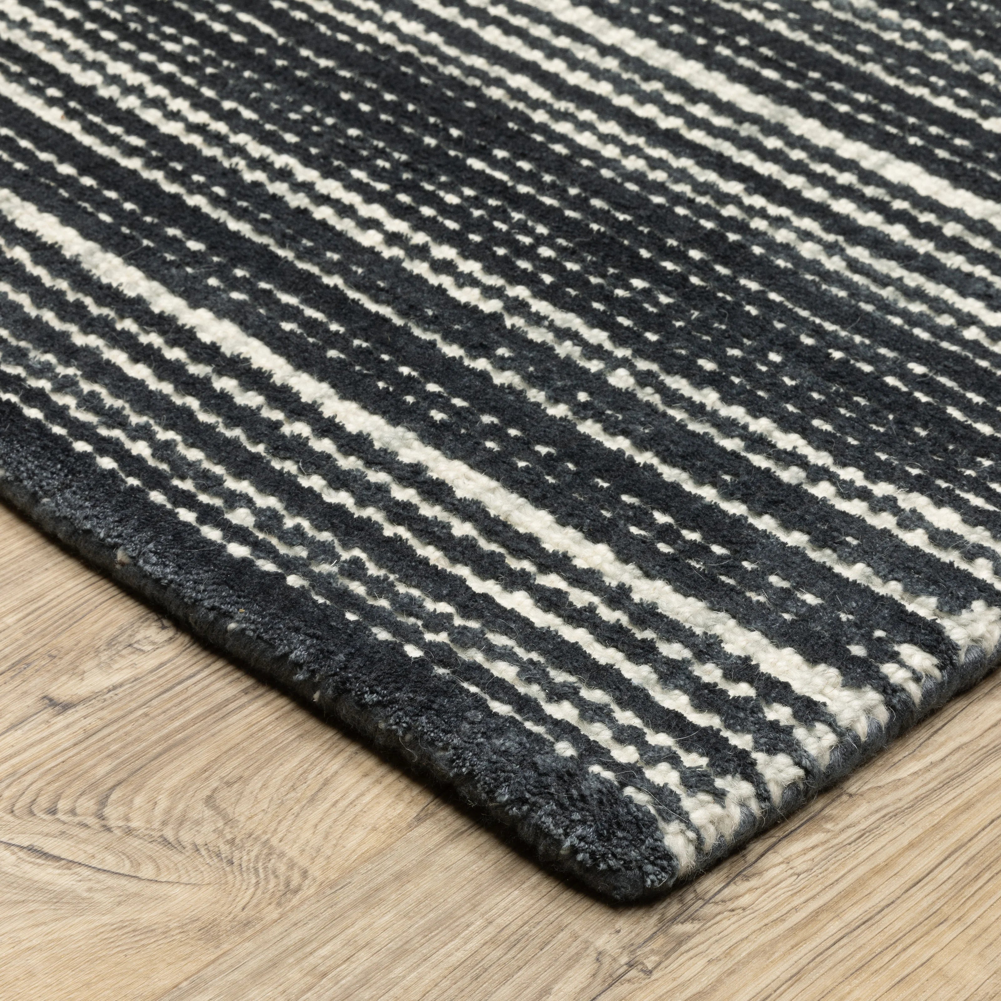 Charcoal grey striped wool rug with horizontal woven texture pattern