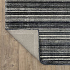 Charcoal grey striped wool rug with horizontal woven texture pattern