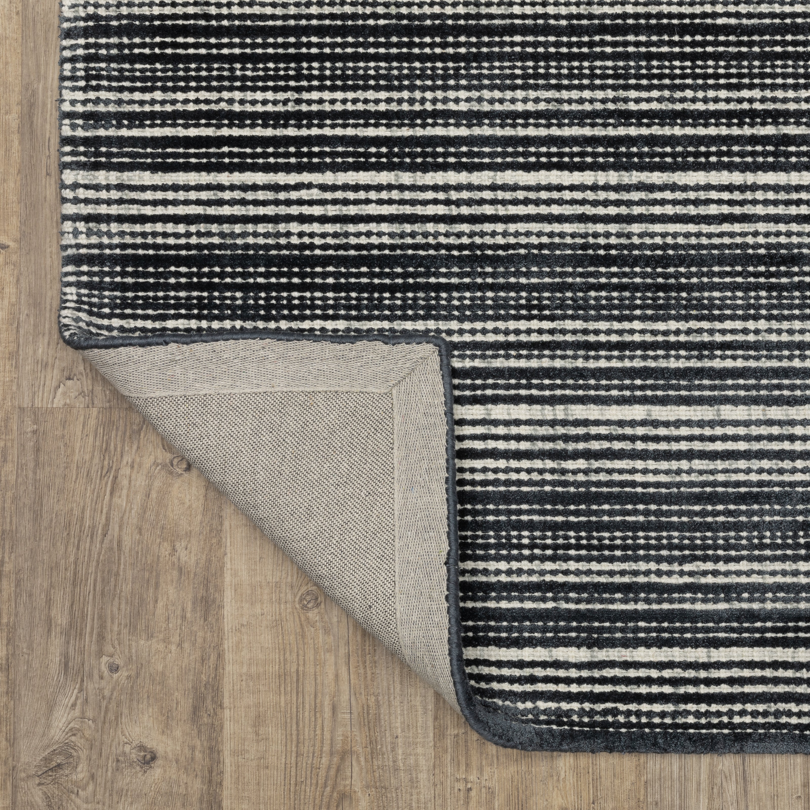 Charcoal grey striped wool rug with horizontal woven texture pattern
