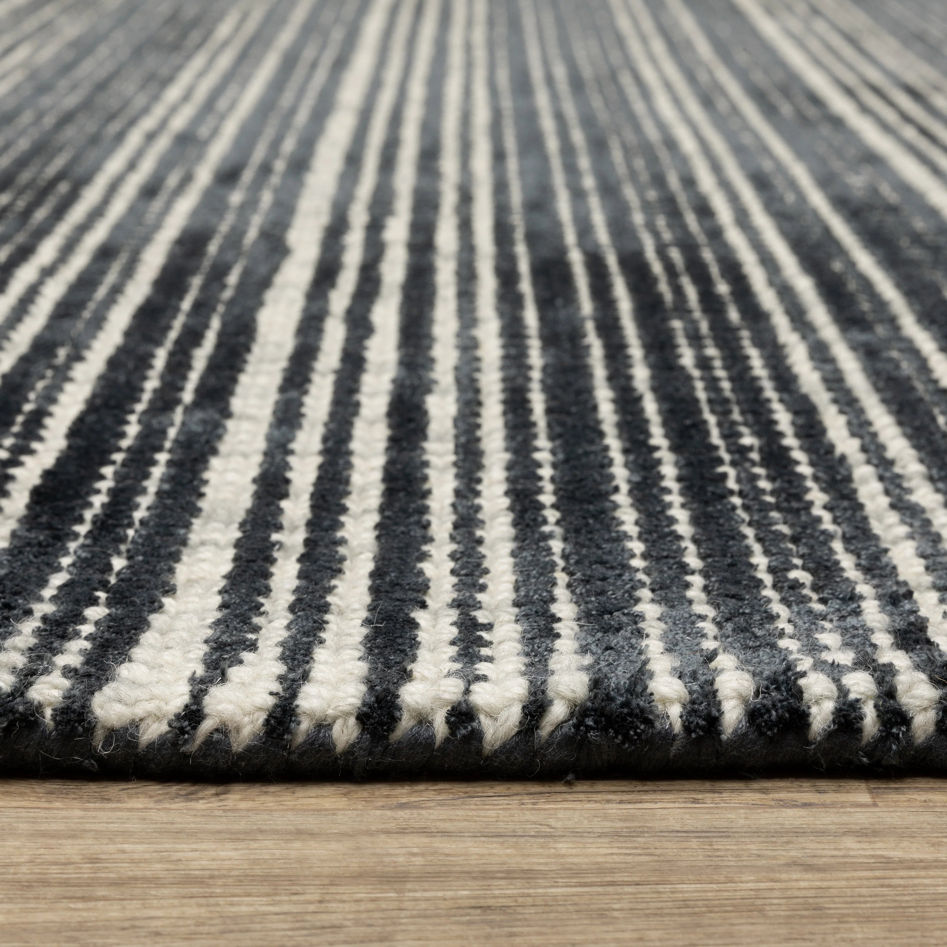 Charcoal grey striped wool rug with horizontal woven texture pattern