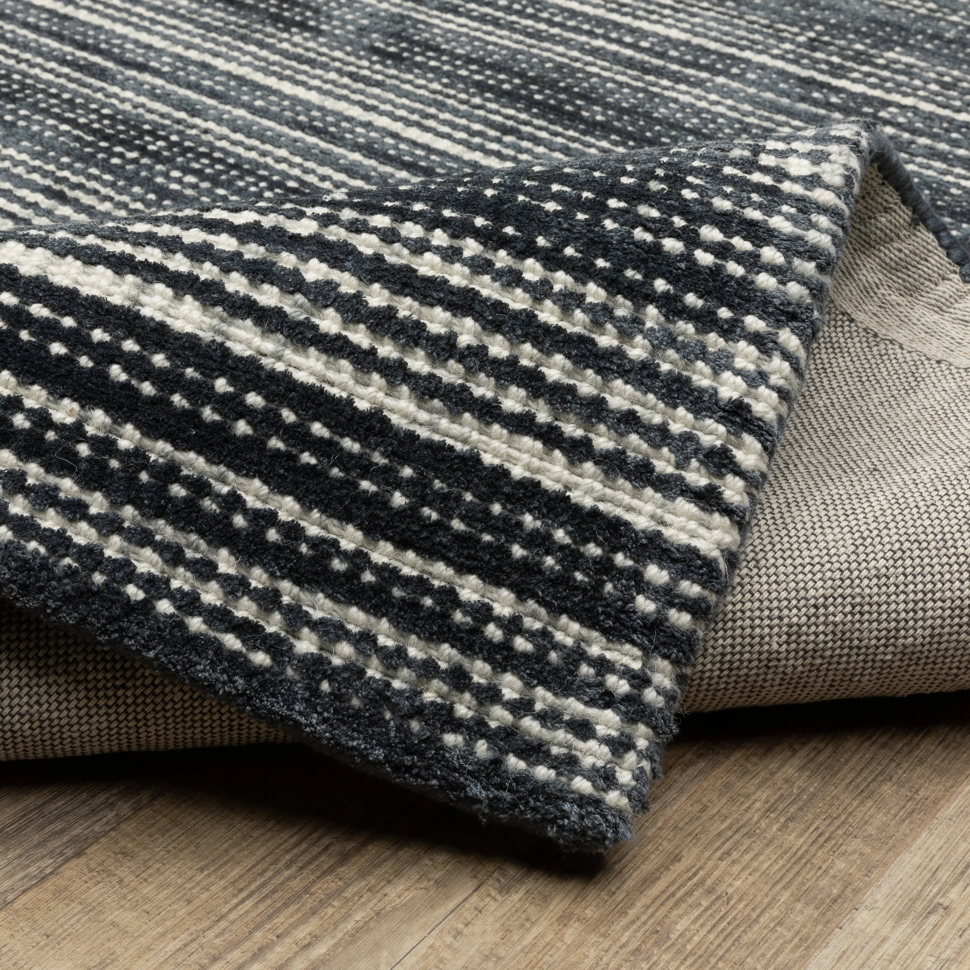 Charcoal grey striped wool rug with horizontal woven texture pattern