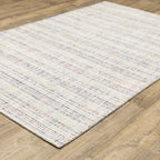 Modern cream and blue striped wool rug on light wood flooring