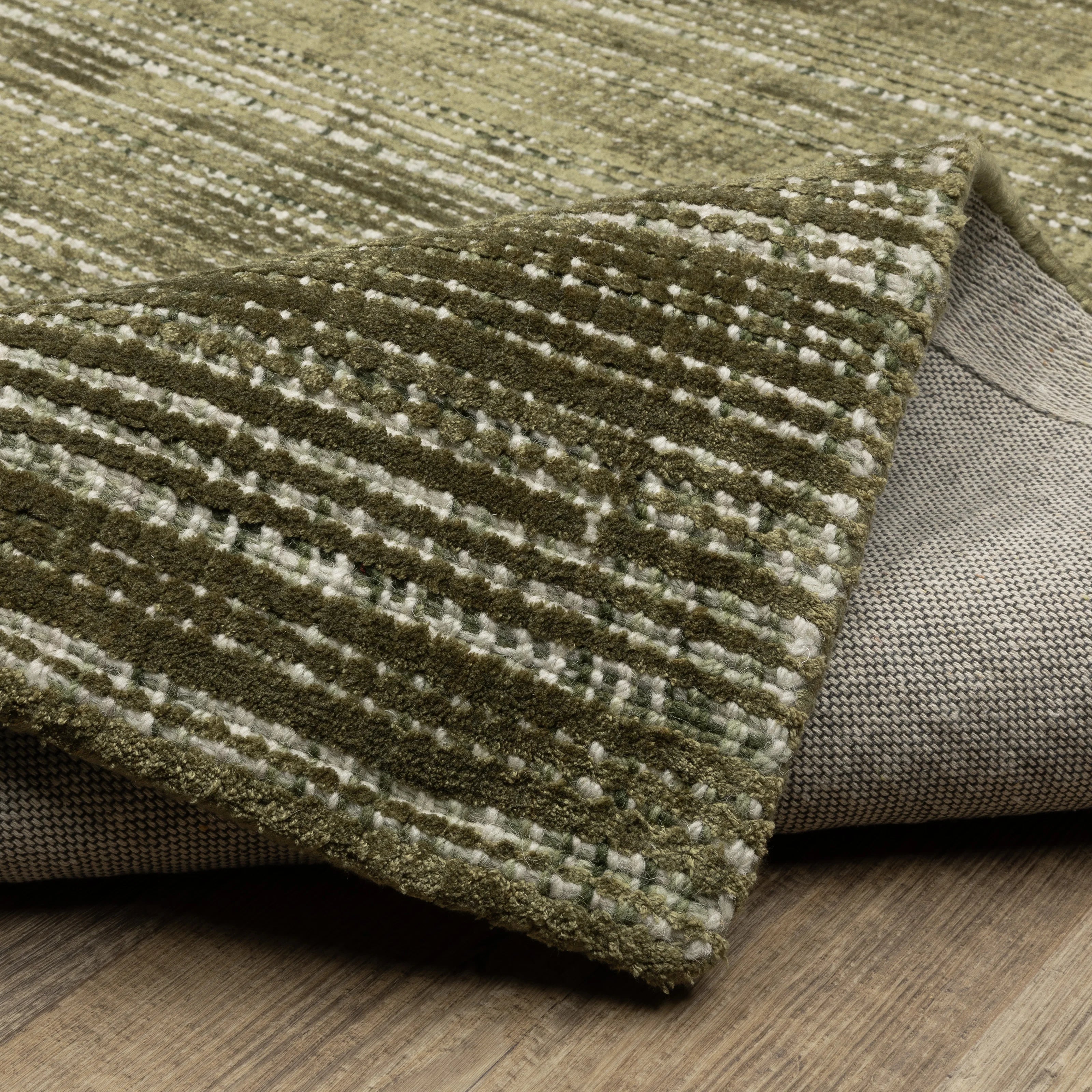 Sage green textured rug with horizontal woven pattern and natural fiber appearance