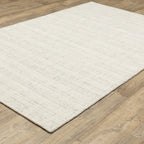 Cream textured wool rug on light wood flooring with visible weave pattern