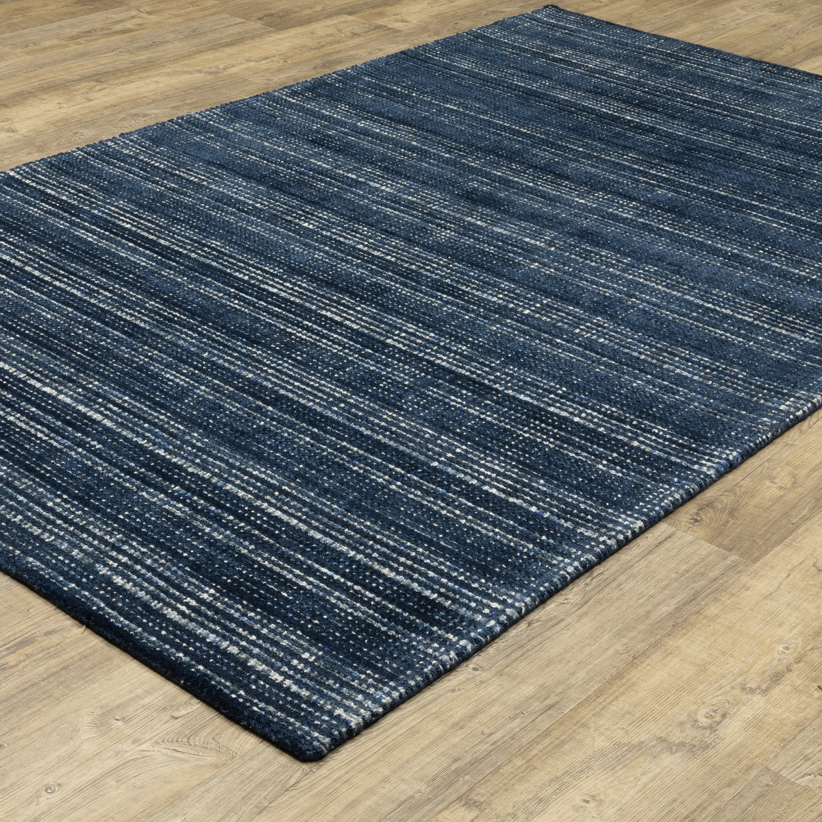 Dark blue textured woven rug with horizontal stripe pattern and neutral accents