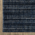 Dark blue textured woven rug with horizontal stripe pattern and neutral accents