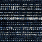 Dark blue textured woven rug with horizontal stripe pattern and neutral accents