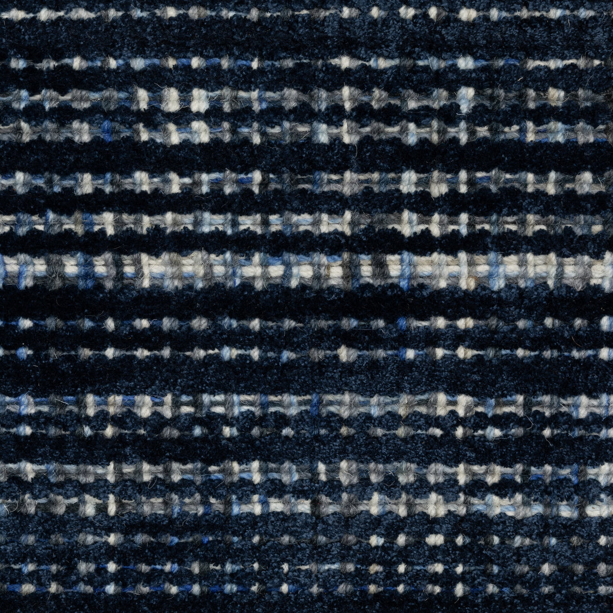Dark blue textured woven rug with horizontal stripe pattern and neutral accents