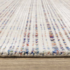 Modern cream and blue striped wool rug on light wood flooring