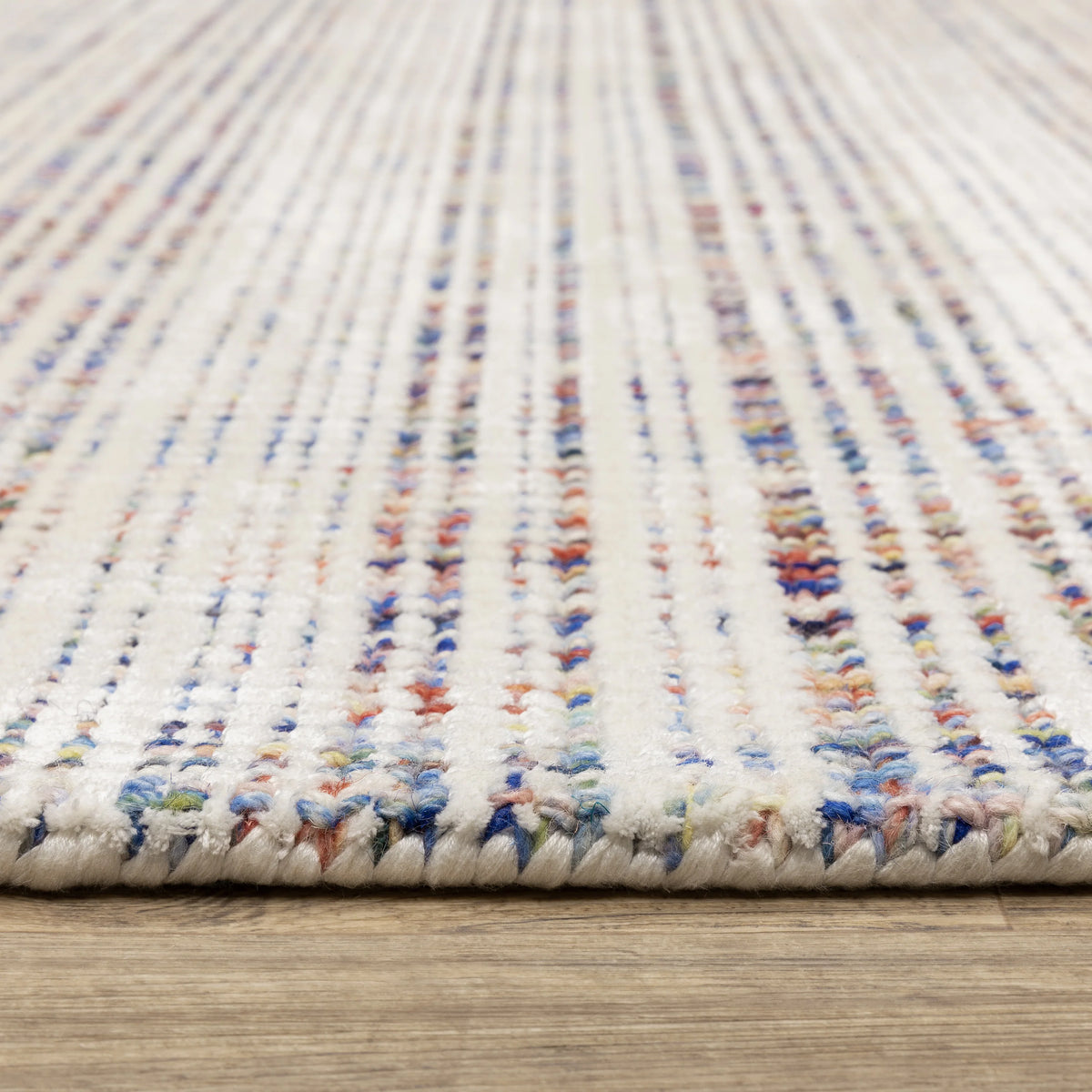 Modern cream and blue striped wool rug on light wood flooring