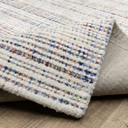 Modern cream and blue striped wool rug on light wood flooring