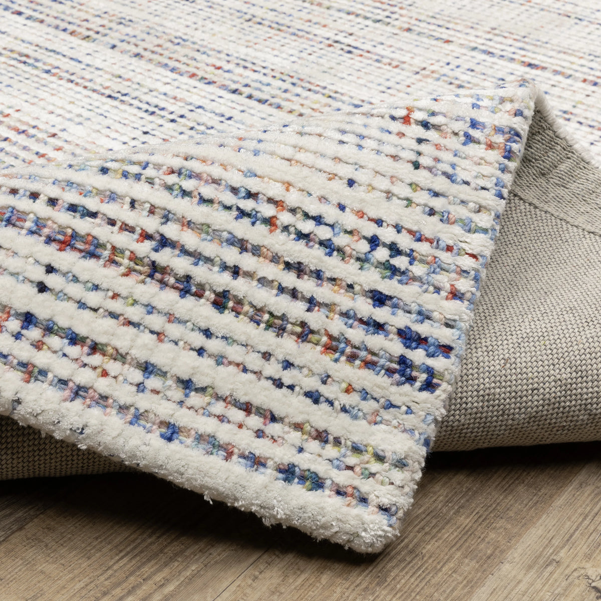 Modern cream and blue striped wool rug on light wood flooring