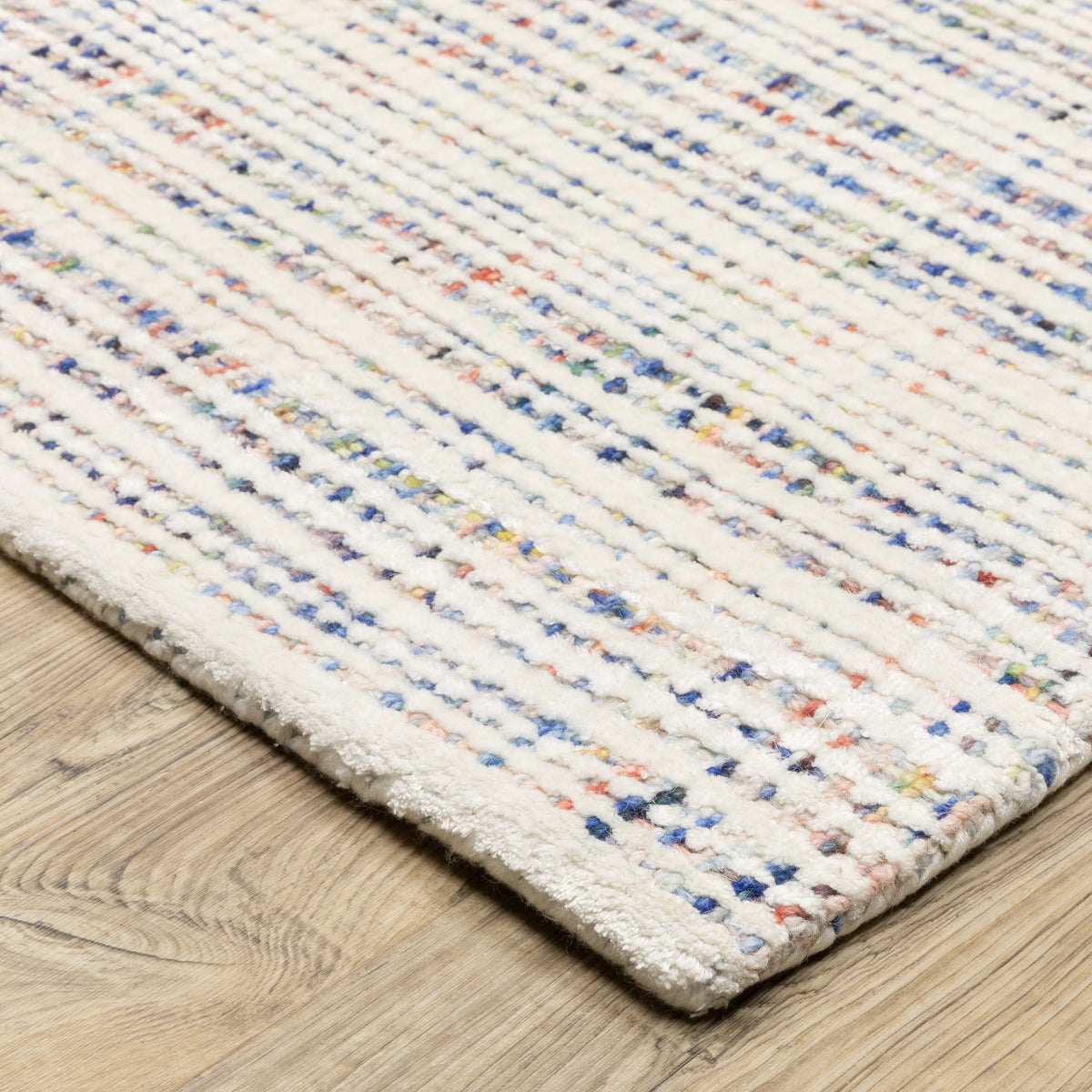 Modern cream and blue striped wool rug on light wood flooring