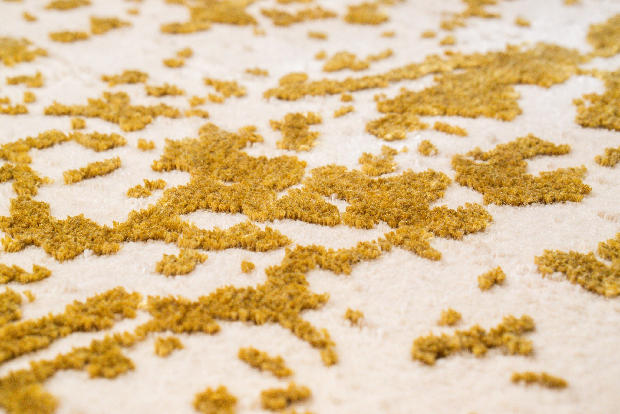 Gold and white distressed texture rug with abstract splatter pattern