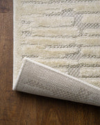 Cream textured rug with geometric brick pattern and subtle tonal details
