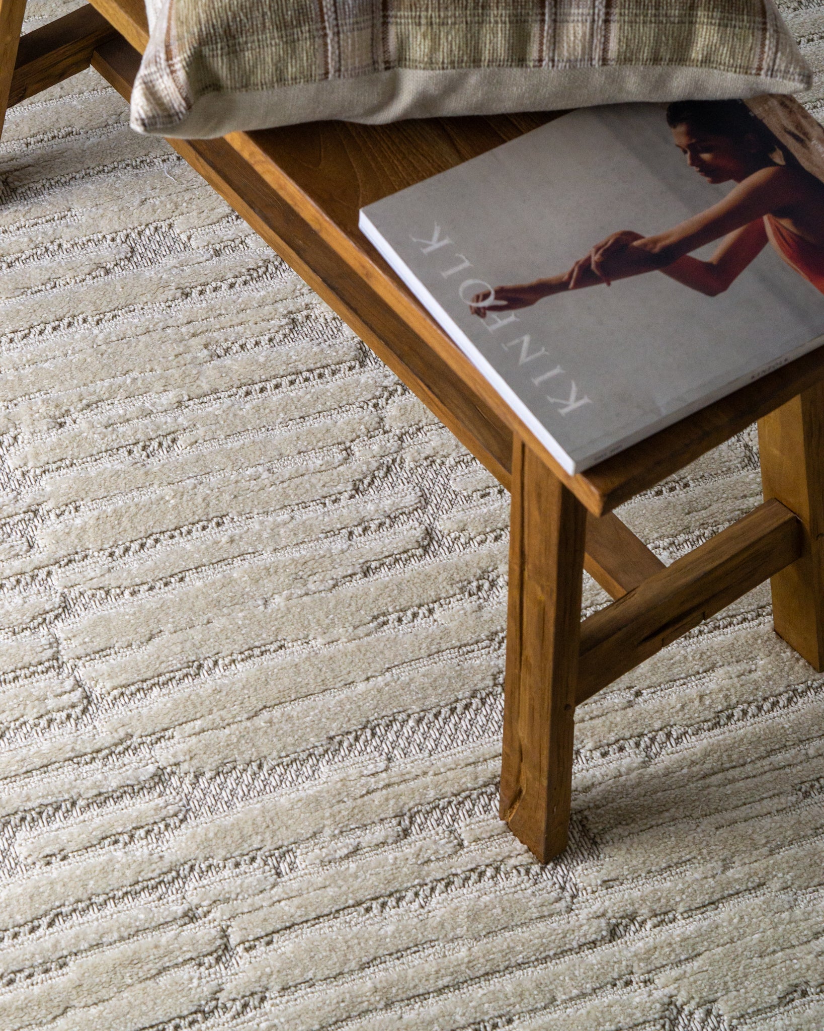 Cream textured rug with geometric brick pattern and subtle tonal details