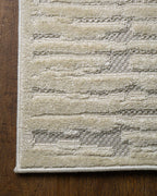 Cream textured rug with geometric brick pattern and subtle tonal details