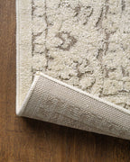 Cream and taupe traditional floral patterned area rug with ornate border