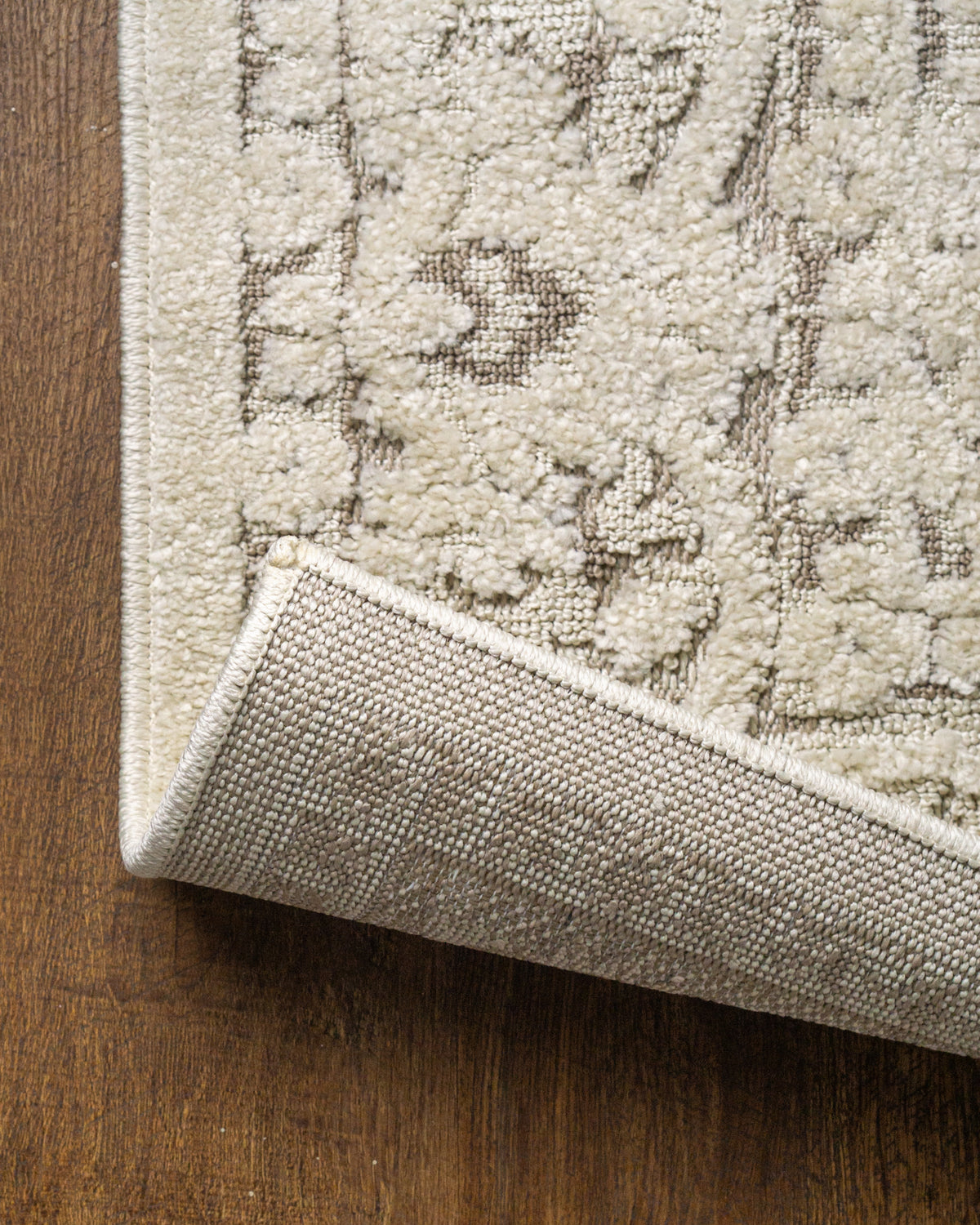 Cream and taupe traditional floral patterned area rug with ornate border